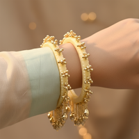 Etnico Traditional Ivory-Tone Bangles with Brass Stud Detailing and Hanging Ghungroo Charms for Women (ADB595Cr)